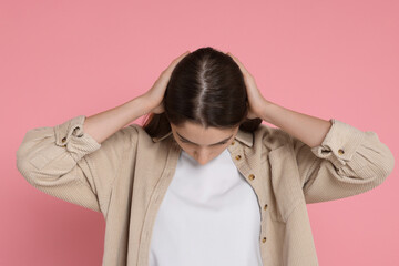 Girl with hair loss problem on pink background