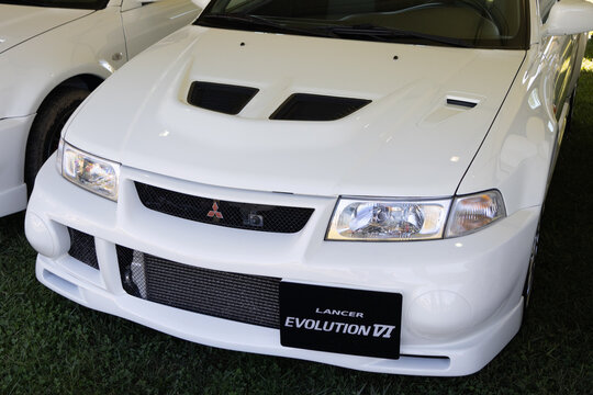 White mitsubishi lancer evolution vi showing front bumper, hood, and headlights
