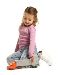 Little girl playing with toy car on white background