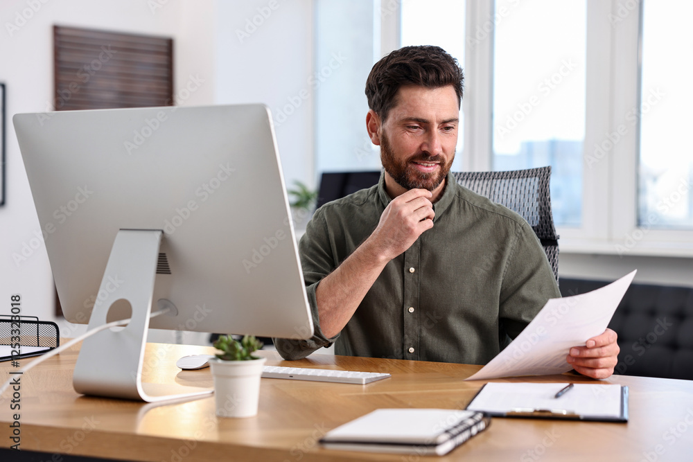 Poster man with document working at table in office