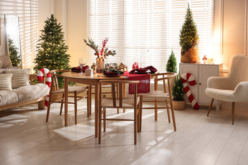 Christmas table setting with stylish dishware and festive decor indoors