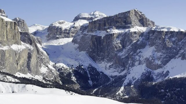 Sunny View of Rocky Mountains in Dolomiti Superski Winter Resort. Pan Shot of Snow Covered Rocky Peaks in Italian Dolomites.