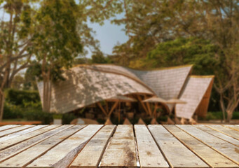 Fototapeta premium Wooden table top on blur night restaurant or cafe background.For montage product display or design key visual layout.View of copy space.