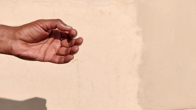 Man counting something on a fingers outside in a sunny day 