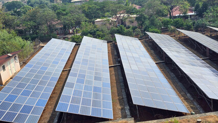 Side angle shot of  Solar panel system near small village in Maharashtra, India © Grower