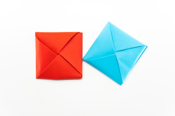 Square envelope made of red and blue paper. Origami envelope on white background