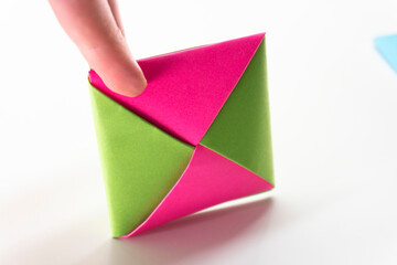 Square envelope made of red and blue paper. Origami envelope on white background