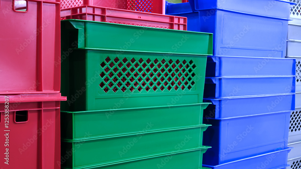 Poster a stack of colorful plastic containers, including green, red, and blue. the containers are piled on 