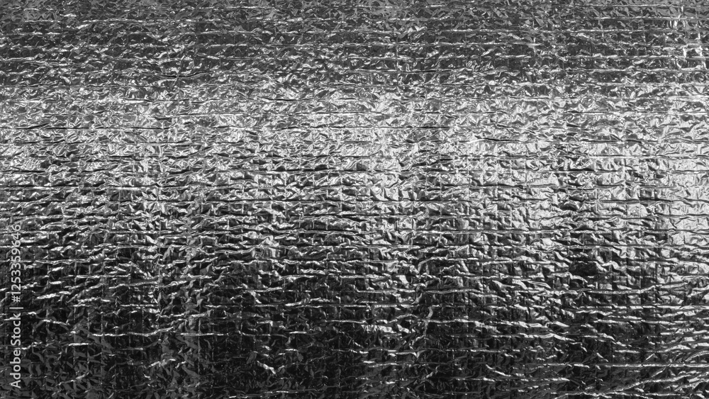 Poster Black and silver foil with shiny surface. Foil is crumpled and has rough texture textured black and white background as a template backdrop banner