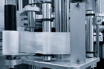 Fragment of the conveyor of sticking labeling machine for packaging food products or...