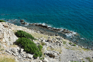Rocky landscape of the western part of Baska Bay in Croatia, where steep cliffs descend towards the...