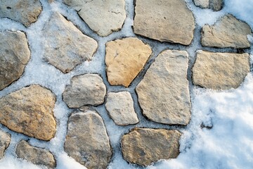 Obraz premium Irregular stone pathway covered in snow. Perfect for winter, nature, and texture themes.