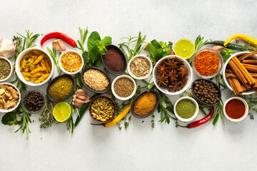 A collection of various spices and herbs on a gray background, perfect for enhancing dishes with...