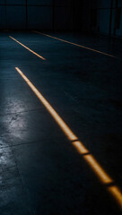 The concrete floor glowing under a spotlight, with dark black and luminous lights casting intricate shadows.