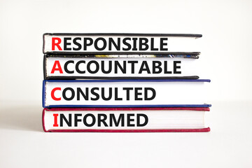 RACI symbol. Concept word RACI Responsible Accountable Consulted Informed on books. Beautiful white...