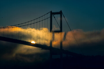 View of July 15 Martyrs Bridge (Bosphorus Bridge) with seagull and sunrise in fog clouds. A foggy...