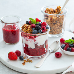Healthy breakfast, fresh greek yogurt, granola and mixed berries