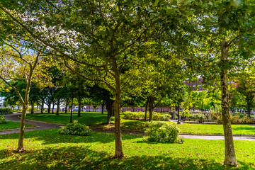 A view towards the waterfront across Christopher Columbus Park in Boston in the early morning in the fall
