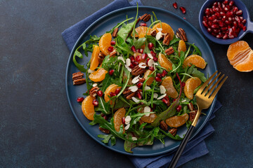 tangerine, ruccola, nuts and pomegranate salad