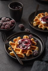 waffles with whipped cream and blackberry sauce