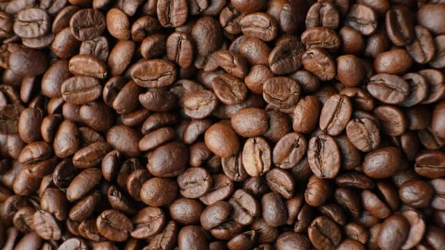 Rotating a caffeine-free decaf coffee beans close-up top view