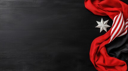 Red and black fabric, star, wood background. Remembrance Day