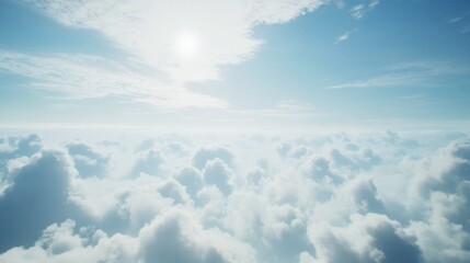 Sky view above cloudscape with sun shining through wispy white formations and clear blue sky