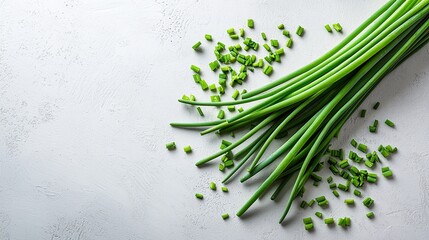 Freshly chopped green onions laid on a light textured surface with additional scattered pieces highlighting their vibrant color