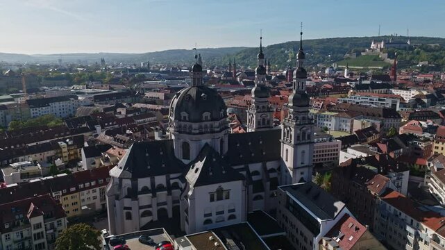Aerial drone view of St. John in Stift Haug in W&uuml;rzburg, Germany, a historic Baroque church Located in the heart of W&uuml;rzburg, this landmark features a striking dome and twin towers . 