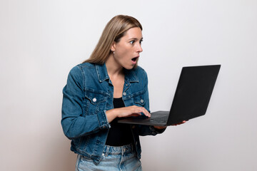 Worried girl holding laptop, focused on screen