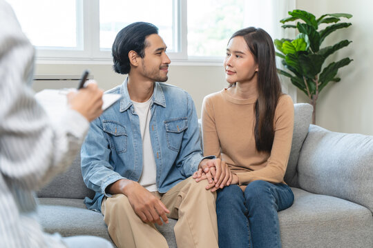 Psychology, depression asian young couple, patient consulting problem mental health with psychologist, psychiatrist at clinic together, husband encouraging by holding hand of wife, therapy health care