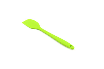 A Geen baking spatula on a white background