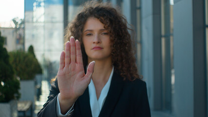 Outdoor portrait Caucasian serious strong woman business girl female businesswoman showing stop...