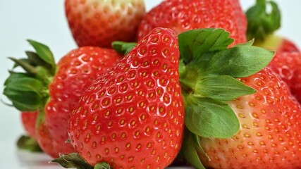 Red ripe strawberries on white background, macro closeup