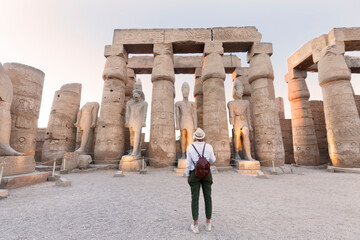 Woman tourist at Luxor Temple at sunset, Luxor, Egypt