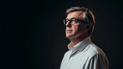Obraz premium Confident businessman in suit,CEO,standing against dark background,portrait,copy space,banner.