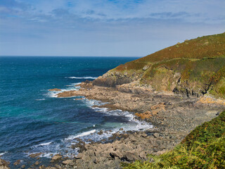 The rugged Britanny coast around Le Diben and Plougasnou in Northern France. Taken on a sunny day in late summer with a blue sky and light clouds from the coast path.