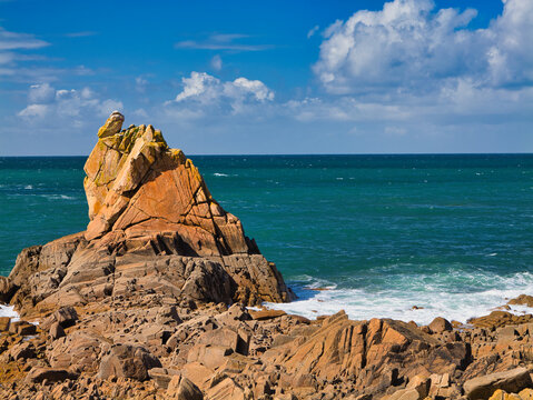 The rugged Britanny coast around Le Diben and Plougasnou in Northern France. Taken on a sunny day in late summer with a blue sky and light clouds from the coast path.