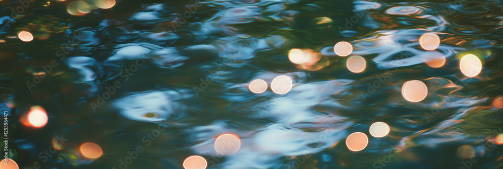 Poster blurred reflection of trees on water surface with vibrant bokeh circles