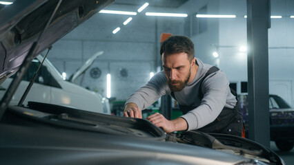 Professional mechanic auto engineer repairman male car service worker Caucasian man guy checking...