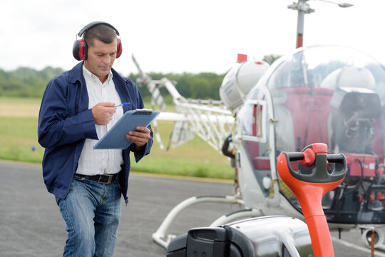 man holding clipboard by gyrocopter