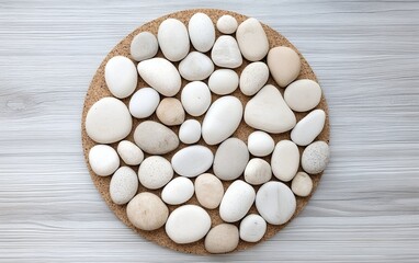 Light beige and white pebbles in a round pattern on a cork base with smooth surfaces and clean lines
