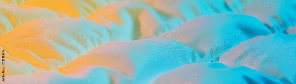 Poster quilted fabric's macro texture shows stitched patterns and padding on a bright background