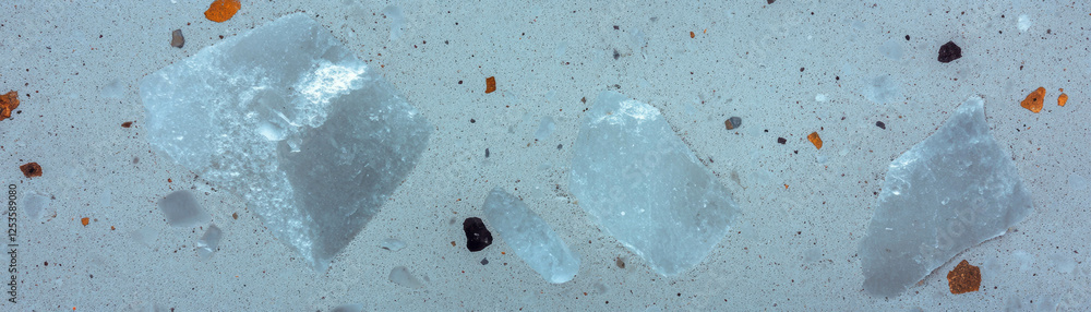 Poster exposed aggregate salt finished concrete with decorative texture and bright background