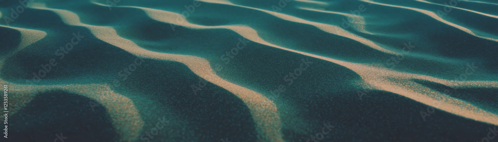 Poster Rippling patterns and fine grains of sand create a mesmerizing texture on a bright surface