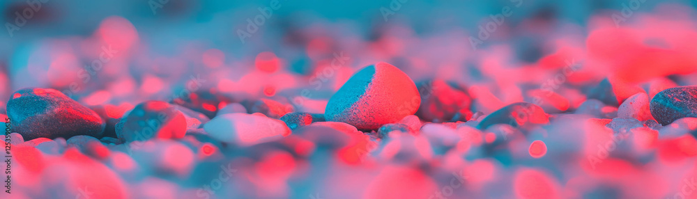 Poster small pebbles on the sand highlighted with neon red in a vibrant background
