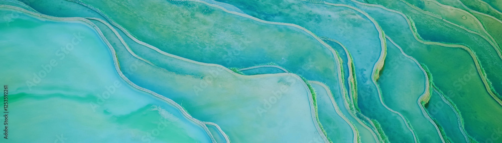 Poster exploring vibrant terraced rice fields with a gentle stream and soothing blue backdrop