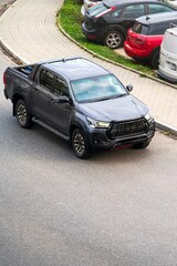 Fototapeta premium Pickup vehicle among parked cars