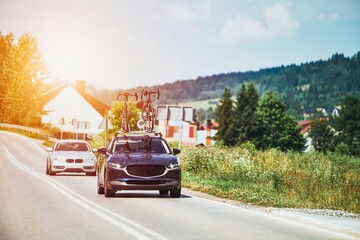 Naklejka premium Cars driving on a road with bikes on the roof