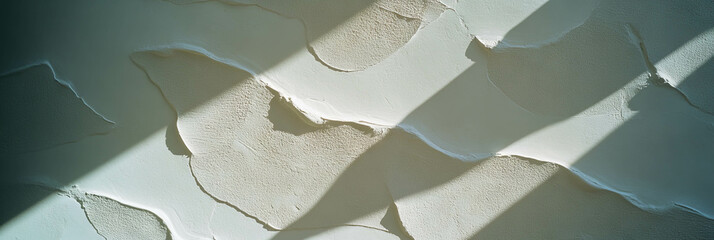 Rough texture of Venetian plaster with long shadows and bright background